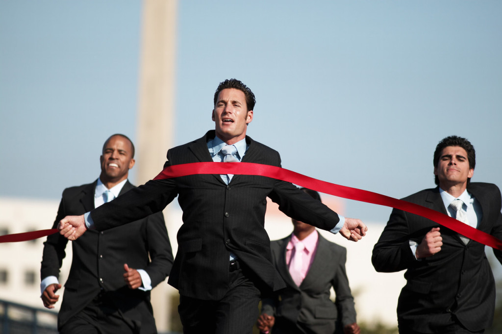 Businesspeople Running Towards Finish Line